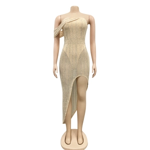 Detail of evening dress showing silver rhinestones on champagne mesh and asymmetric slit