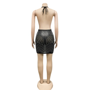 Macro detail of black mesh dress featuring radial rhinestones and V-line geometric patterns