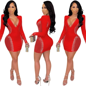 Detail of red deep V-neck dress featuring sheer mesh panels and sparkling rhinestones