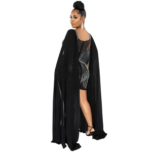 Detail of elegant black bodycon evening dress featuring sparkling rhinestones and mesh cape