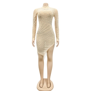 Detail of sheer mesh dress with rhinestones, pearls and beaded fringe hemline