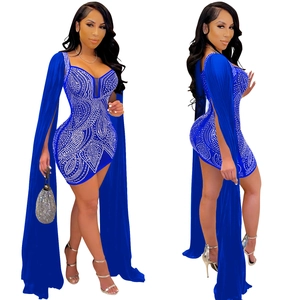 Detail of royal blue bodycon dress with silver rhinestones and dramatic split cape sleeves
