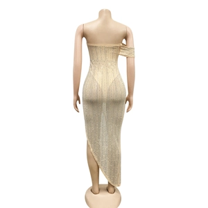 Detail of nude evening dress featuring shimmering vertical rhinestones and mesh fabric