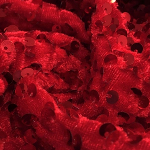 Macro detail of red sequin fabric on velvet base for women's halter dress