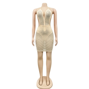 Detailed view of champagne halter dress featuring silver rhinestones and waist cut-outs