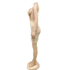 Detailed side view of beige mesh party dress featuring sparkling rhinestones and open back