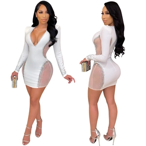 Close-up of sexy white deep V-neck mini dress with sheer mesh and rhinestone details