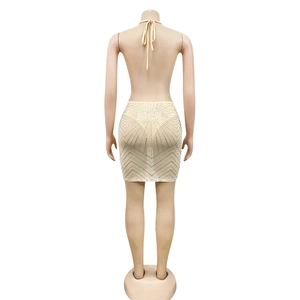 Detailed back view of a beige two-piece set with silver rhinestones and halter neck design