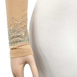 Detail of sheer mesh sleeve with colorful rhinestones on a nude one-shoulder jumpsuit