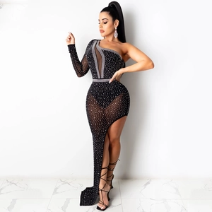 Detail of black one-shoulder dress with mesh panels and shimmering rhinestone accents
