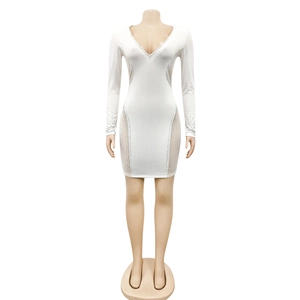 Close-up of white deep V-neck dress with rhinestone trim and mesh patchwork details