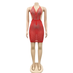 Macro detail of red halter dress featuring rhinestones and side cut-outs for party wear