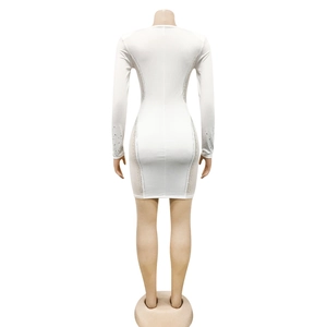 Close-up of white slim dress with detailed silver rhinestones on sleeves and side seams