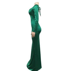 Detail of dark green velvet floor-length dress with elegant lace-up back and slim mermaid cut