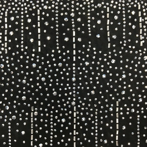 Dettaglio ravvicinato del tessuto a rete nera con strass scintillanti e paillettes d'argento