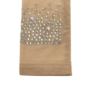 Close-up of nude mesh fabric with iridescent rhinestones and fine stitching detail