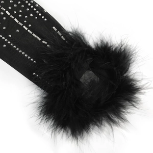 Dettaglio di maniche in rete nera con strass argento e finiture in piume eleganti