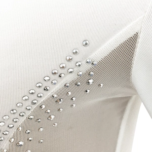 Detailed view of white mesh dress featuring shimmering rhinestones and fine knit texture