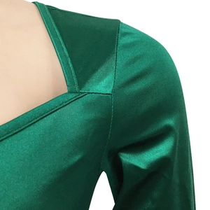 Detailed close-up of dark green satin dress showing V-neck design and smooth fabric texture