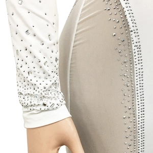 Close-up of white party dress showing intricate silver rhinestones and mesh stitching