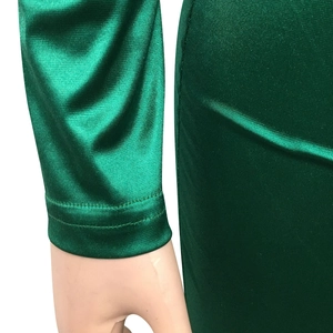 Detailed close-up of emerald green satin sleeve cuff with professional double-needle stitching