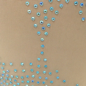 Macro detail of nude mesh fabric with iridescent AB rhinestones for evening wear