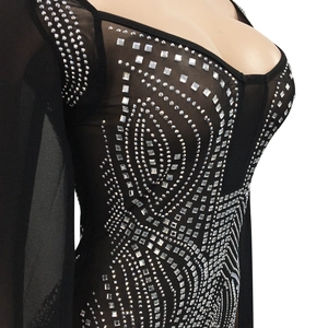 Close-up detail of silver rhinestones and geometric patterns on black mesh dress