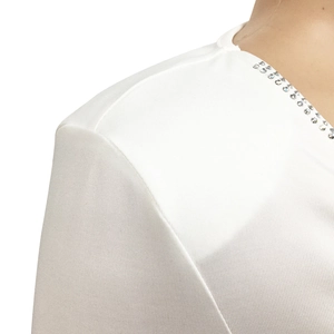 Macro detail of white dress shoulder with elegant sparkling rhinestones decoration