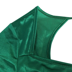 Close-up of emerald green satin dress with premium stitching and glossy silk texture
