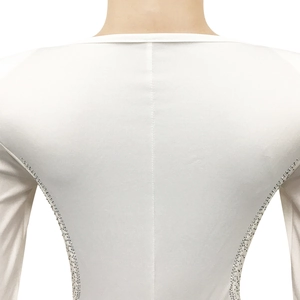 Detailed back view of white long sleeve bodysuit featuring silver rhinestone side trim