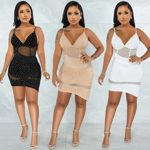 Detail of V-neck sequined party dress with rhinestone mesh and irregular hemline