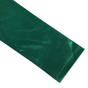 Detail of green glossy satin fabric showing double-needle hem stitching and fine texture