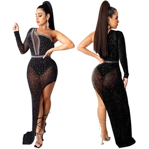 Detail of asymmetrical mesh evening dress with sparkling rhinestones and high slit design
