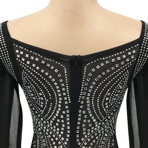 Detail of silver rhinestones and invisible zipper on the back of a black mesh dress