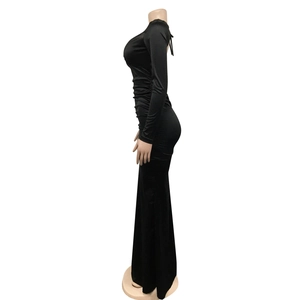Side view of backless black maxi dress with cross strap details and floor length hem