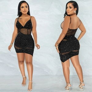 Detail of black V-neck slip dress featuring rhinestone accents and sheer mesh panels