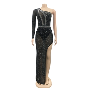 Detail of sheer mesh dress with silver rhinestones and high slit for party wear