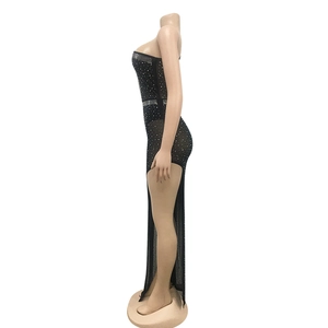 Detail view of black sheer mesh dress featuring shimmering rhinestone accents and high slit