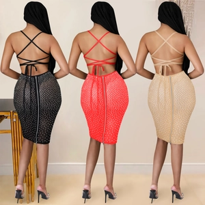 Detail of cross-back straps and rhinestone embellishments on party dresses in three colors