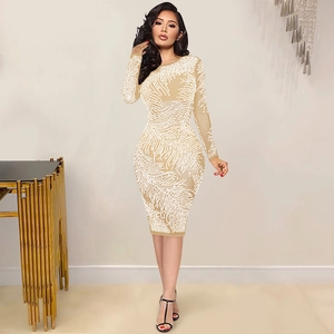 Detail of champagne midi dress featuring intricate white pearl beaded feather patterns
