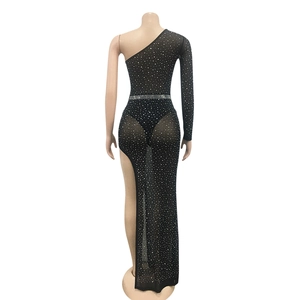 Detail of black one-shoulder mesh dress featuring sparkling rhinestones and a high side slit