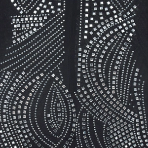 Detail of sheer mesh fabric with silver rhinestones and intricate paisley patterns