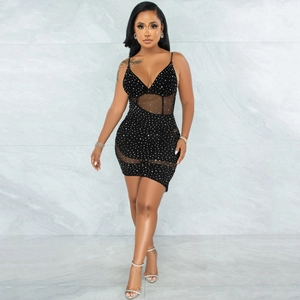 Detail of a black bodycon dress featuring sheer mesh panels and sparkling rhinestones