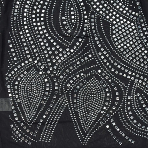 Detail of sheer black mesh fabric with intricate silver rhinestone geometric patterns