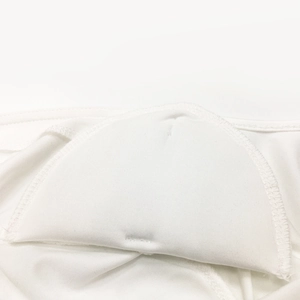 Close-up of a white padded shoulder insert with knit fabric and curved stitched edging