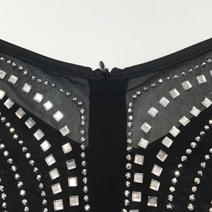 Macro detail of sexy mesh dress featuring symmetric square rhinestones and black zipper