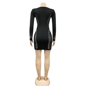 Close-up of sheer mesh side panels and silver rhinestone accents on black dress back