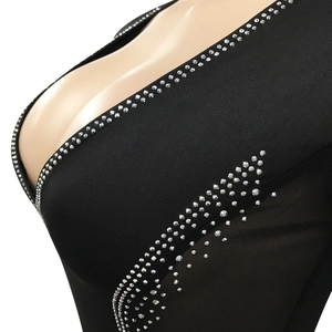 Detail of sexy deep V-neck dress with silver rhinestones on black elastic fabric