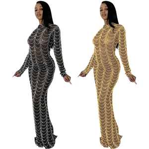 Detail of sheer mesh maxi dress with sparkling sequin wave patterns in black and gold