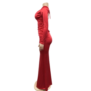 Detail of deep red backless dress with lace-up straps and high-gloss satin fabric